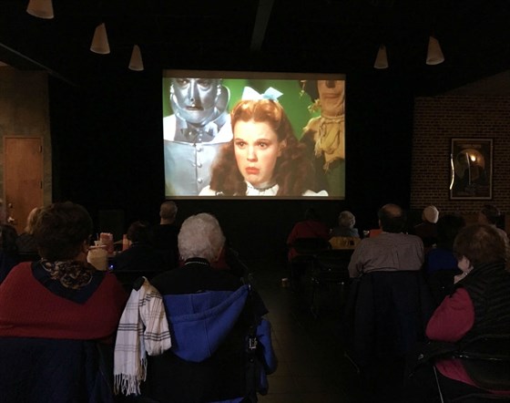 Attendees of Making Memories watching a clip from The Wizard of Oz